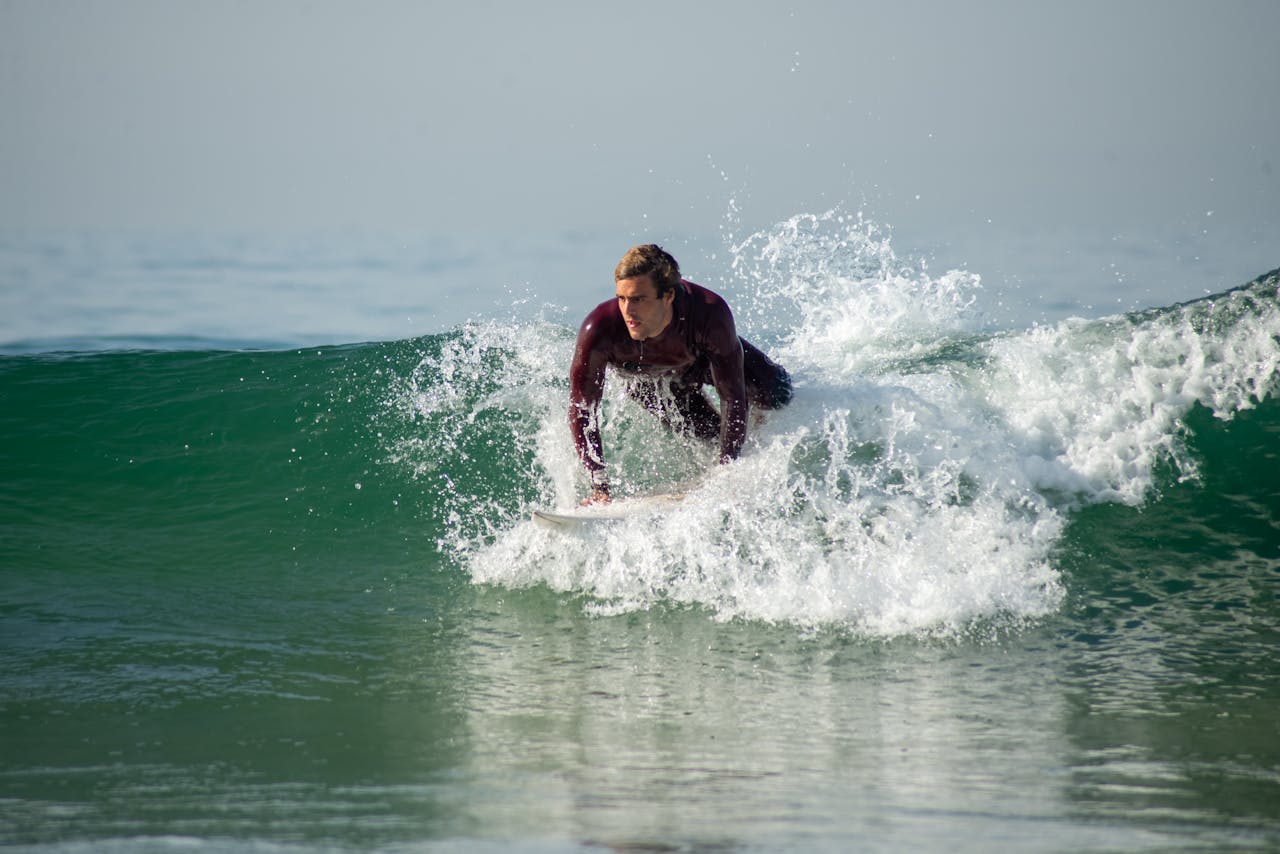 A surfer skillfully rides a wave on the coast of Portugal, showcasing dynamic surfing action.